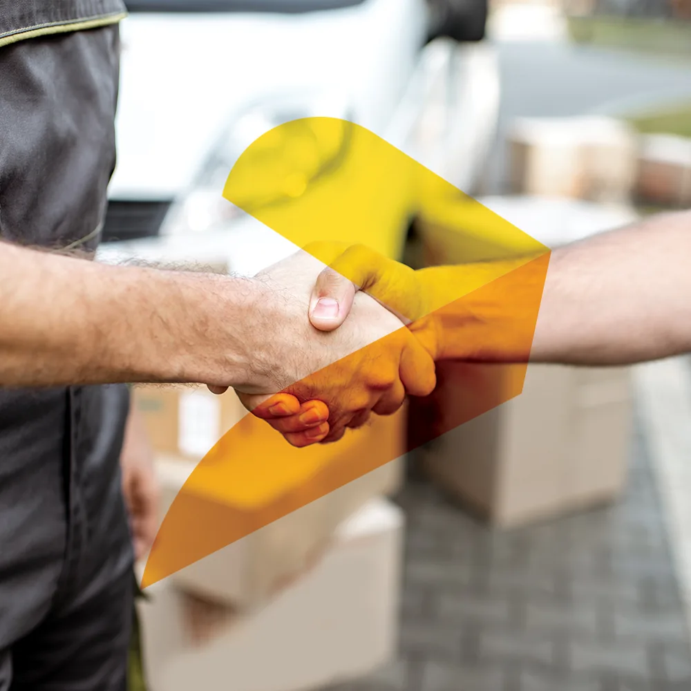 A handshake in front of a removals van